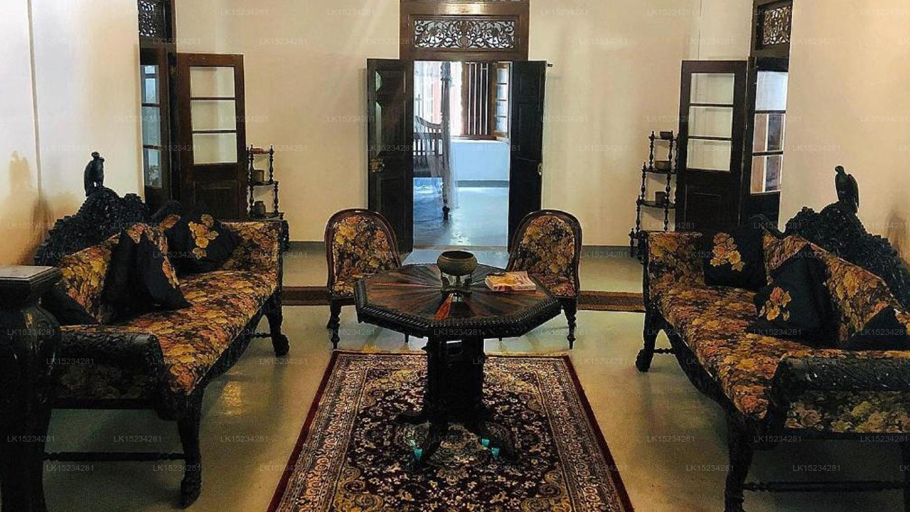 Decorative interior room with ornate furniture and a central table.
