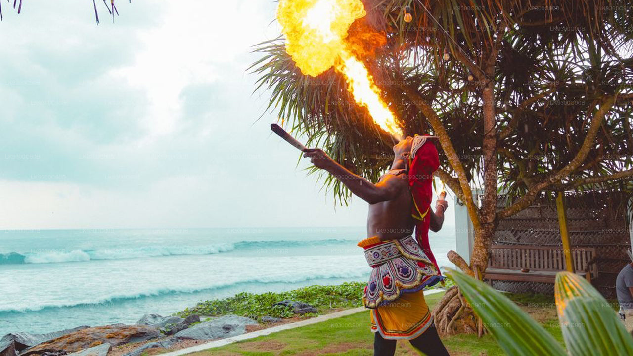 Person performing with fire on a tropical beach