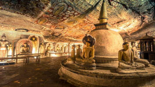 Interior view of Dambulla Cave Temple with illuminated ceiling murals and Buddha statues